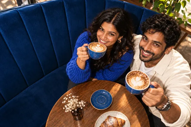 AI-created illustrative photo of two fictional adults at a cafe for Marathi Talo.