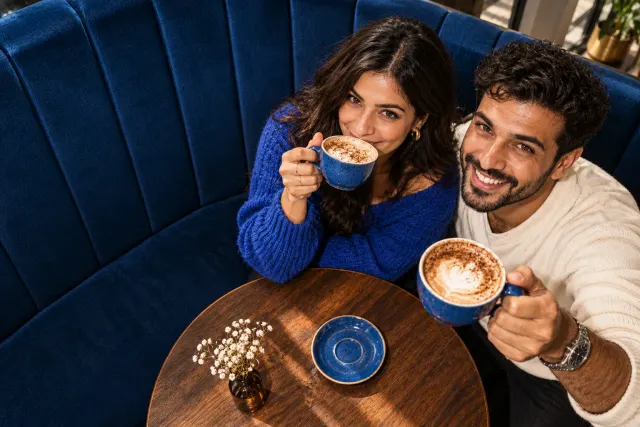 AI-created illustrative photo of two fictional adults at a cafe for Persian Talo.