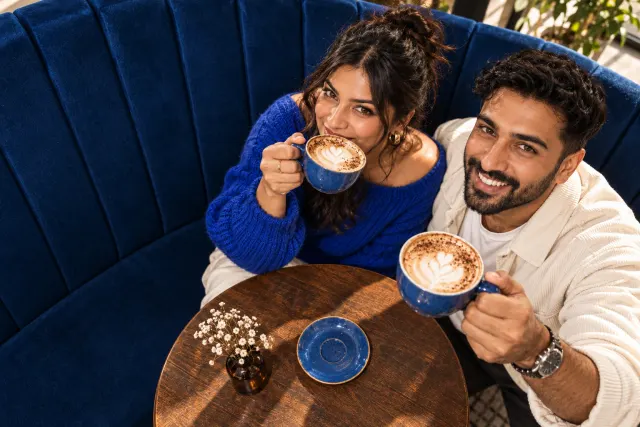 AI-created illustrative photo of two fictional adults at a cafe for Punjabi Talo.