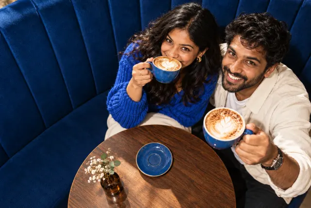 AI-created illustrative photo of two fictional adults at a cafe for Telugu Talo.