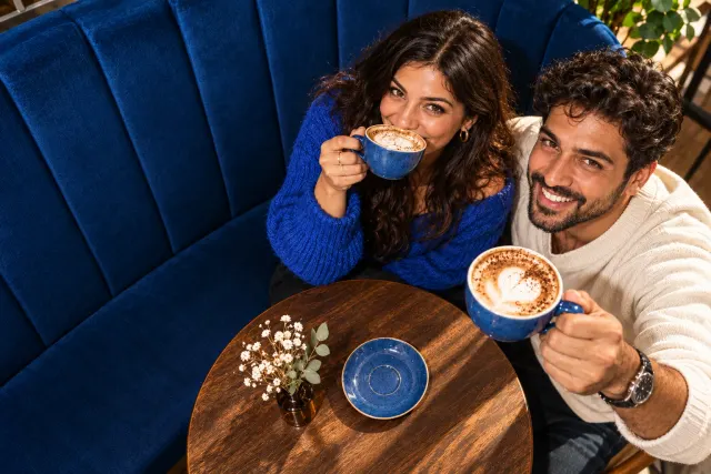 AI-created illustrative photo of two fictional adults at a cafe for Turkish Talo.